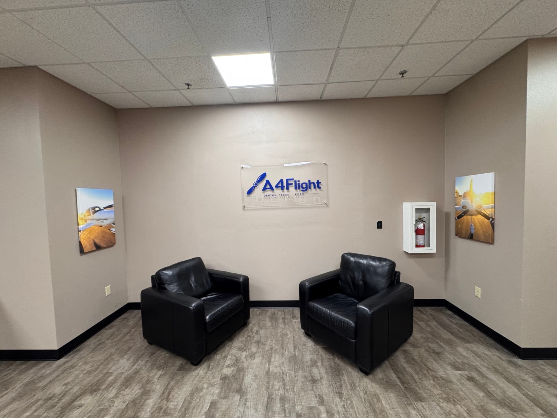 A4Flight office lounge with two chairs beneath the real club logo