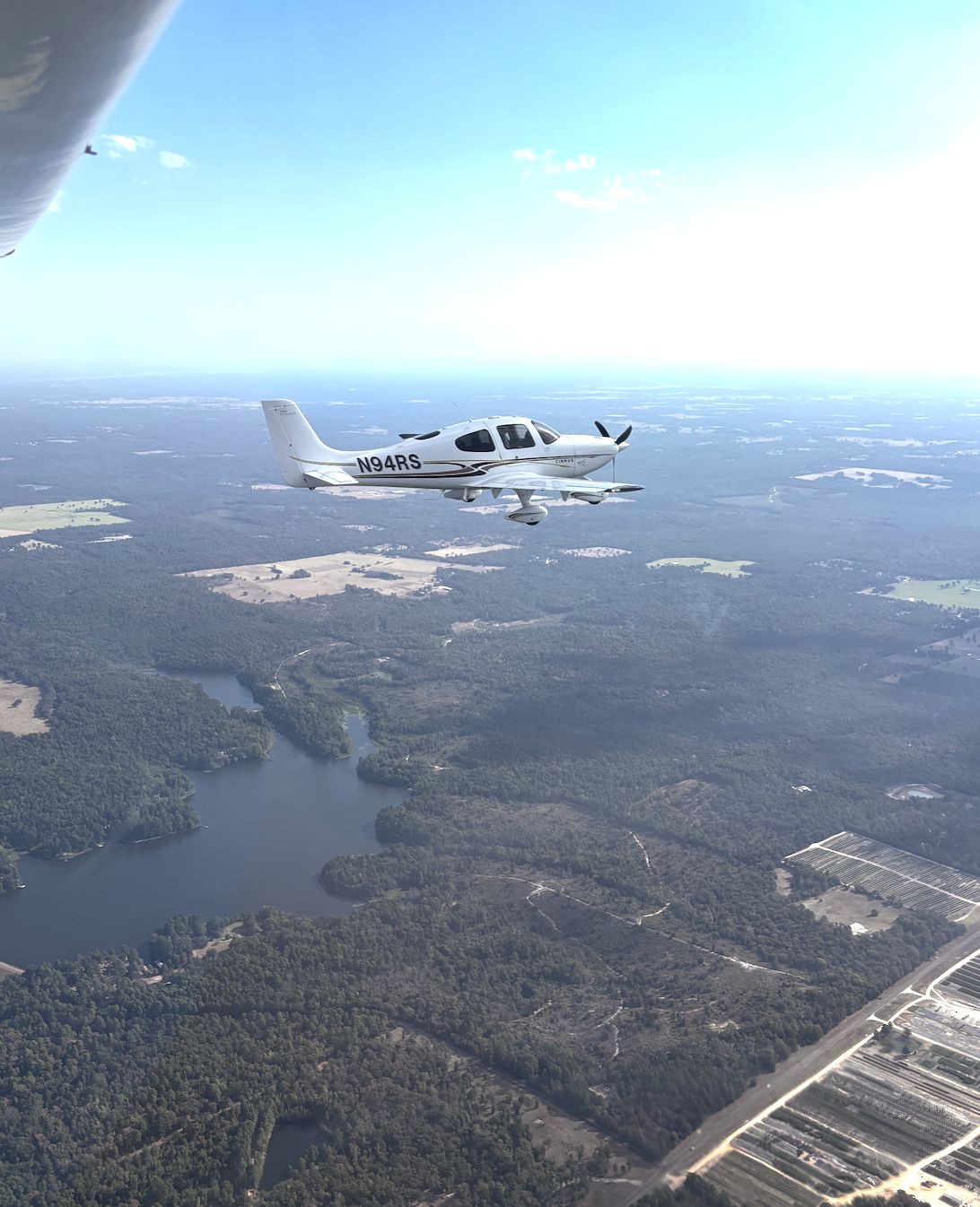 Cirrus SR20 in flight over the water