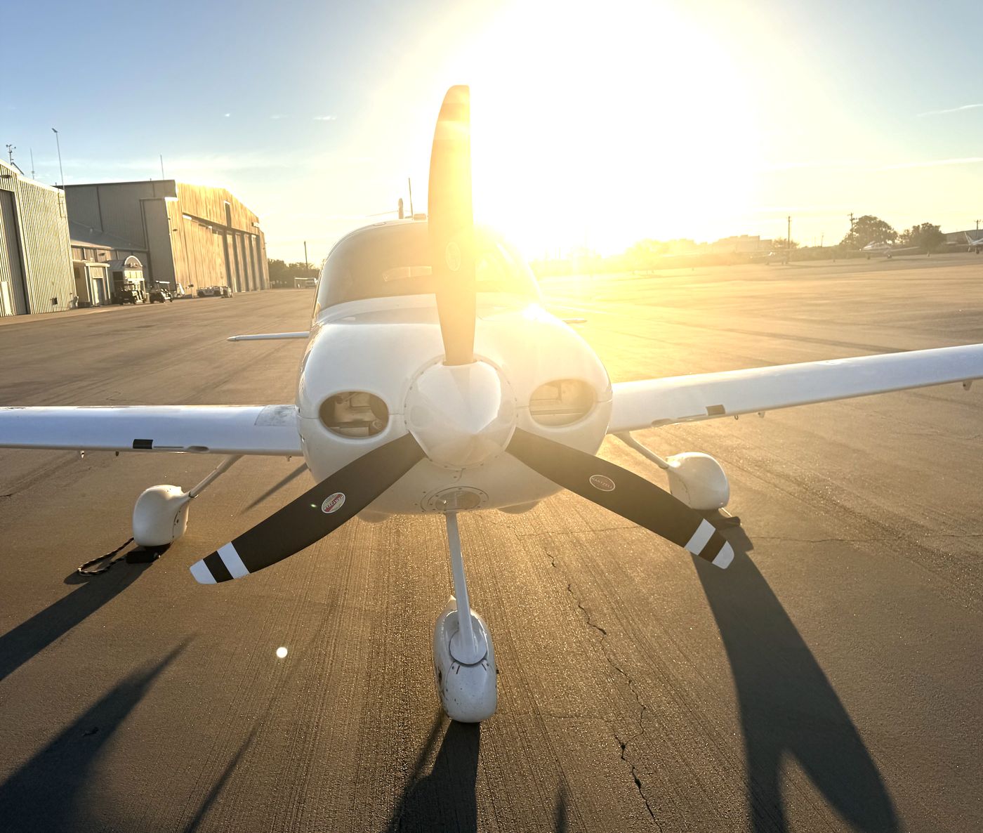 Close view of a Cirrus SR20 nose and propeller in warm evening light