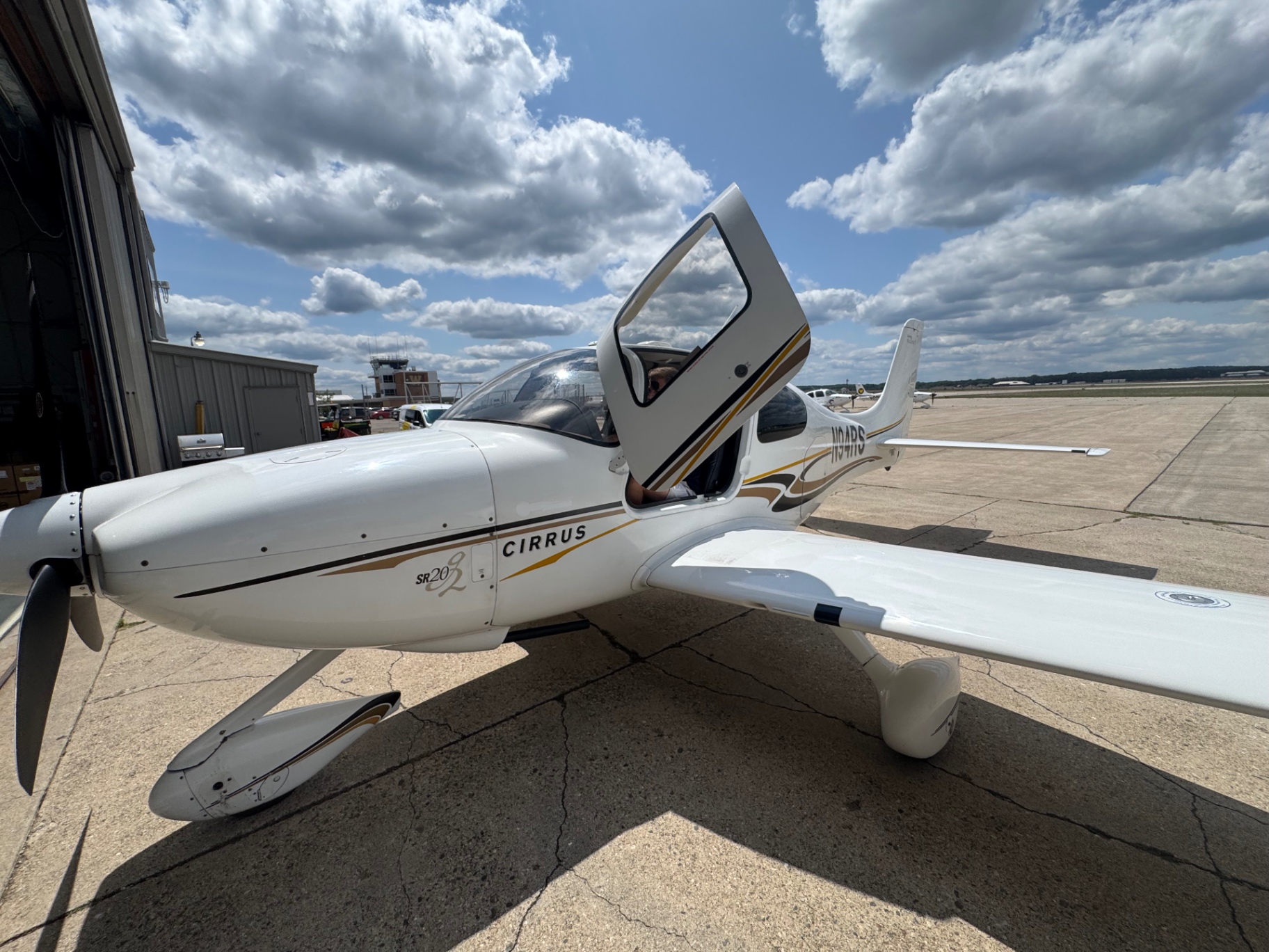 Cirrus SR20-G2 with the cabin door raised on the ramp