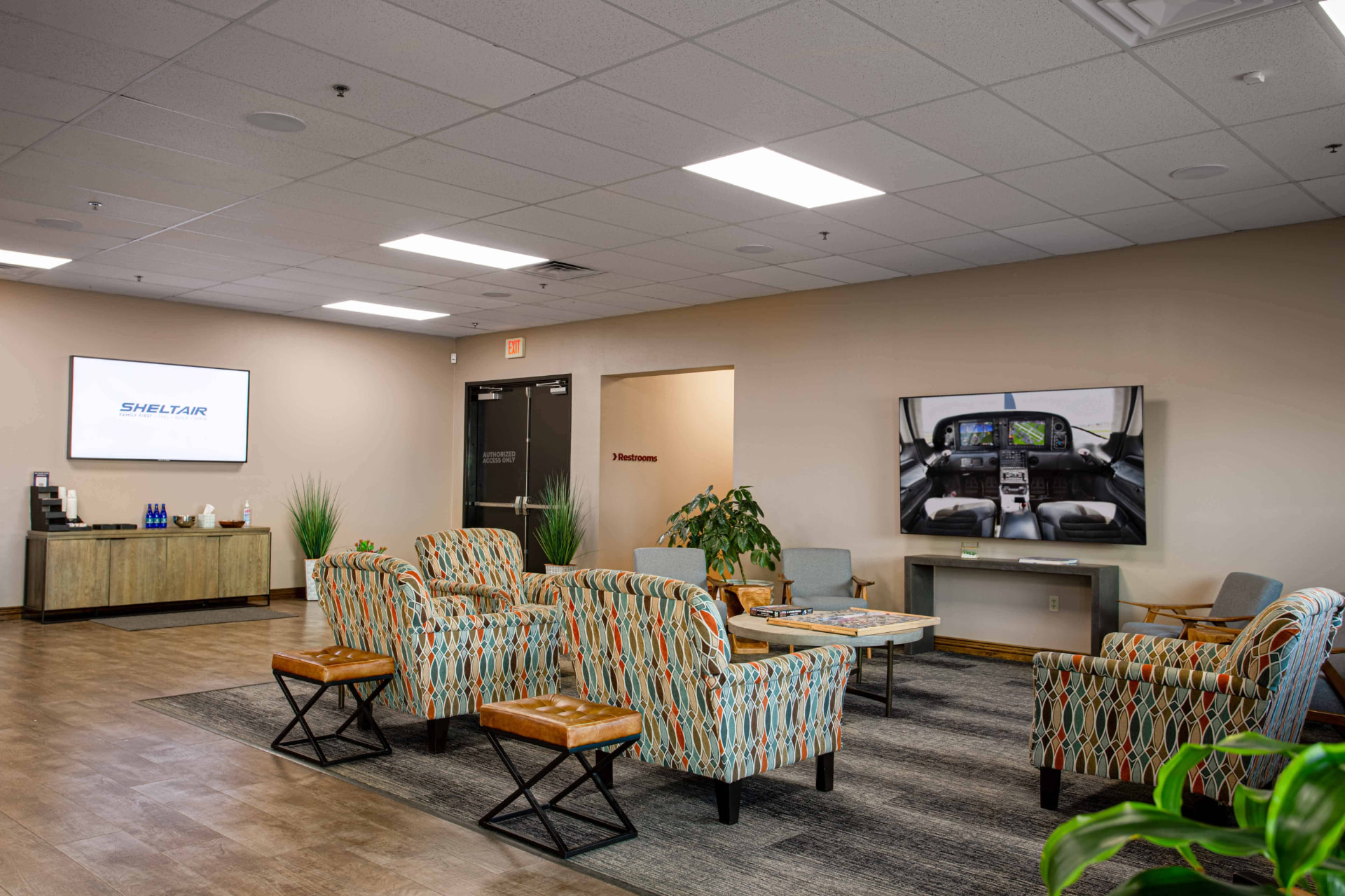Sheltair lounge seating with displays showing airport and cockpit imagery