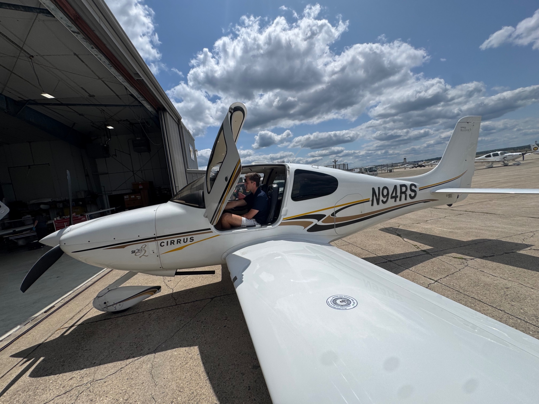Pilot seated in Cirrus SR20-G2 N94RS with the door raised