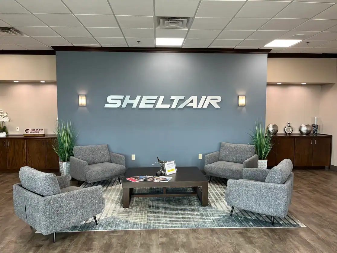 Sheltair reception seating area with the Sheltair wordmark on the wall