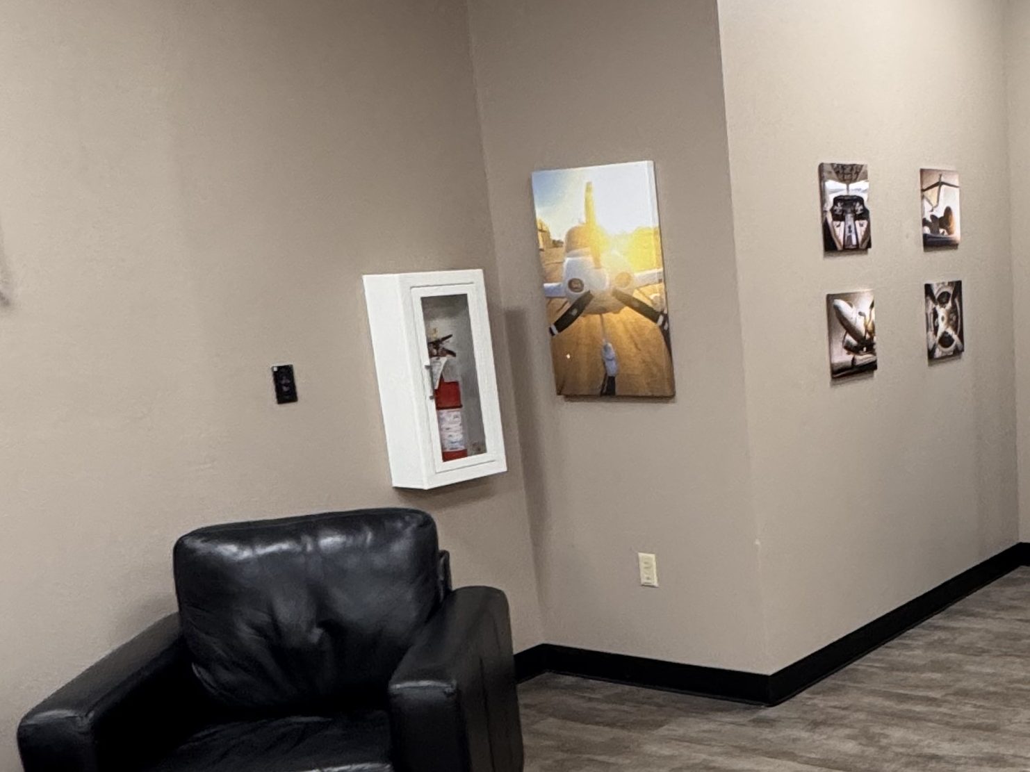 A quiet corner of the A4Flight office with a leather chair and aviation prints on the wall.