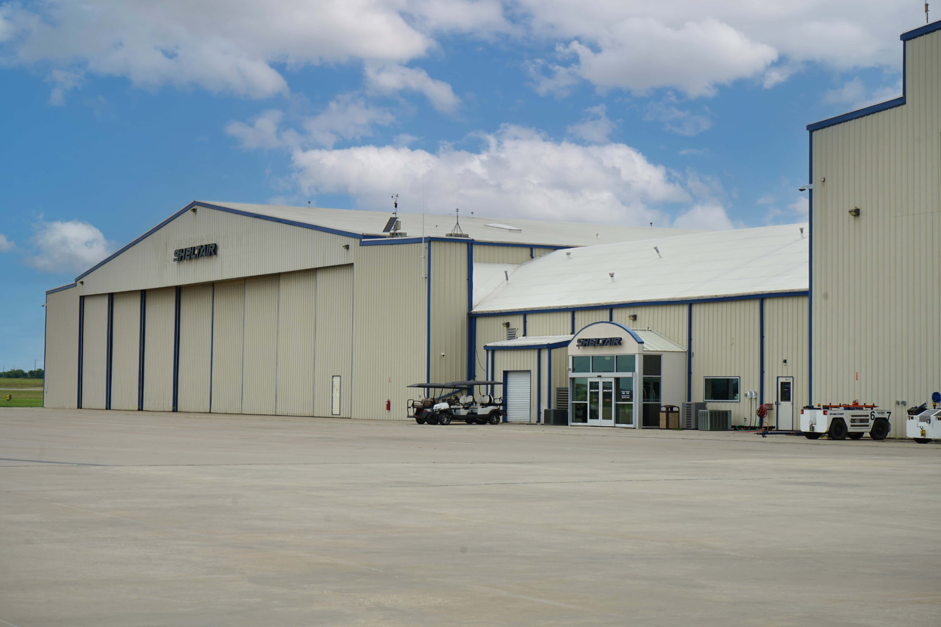 Sheltair hangars and the FBO entrance seen from the ramp at Denton Enterprise Airport